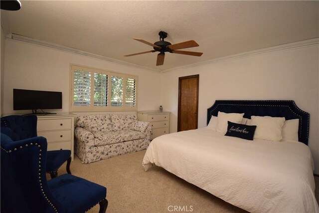 bedroom featuring ornamental molding, carpet flooring, and ceiling fan