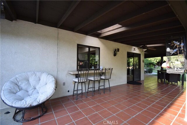 view of patio / terrace with ceiling fan and exterior bar