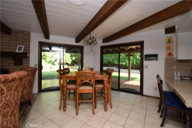 dining area featuring light tile patterned flooring, a wealth of natural light, and beam ceiling