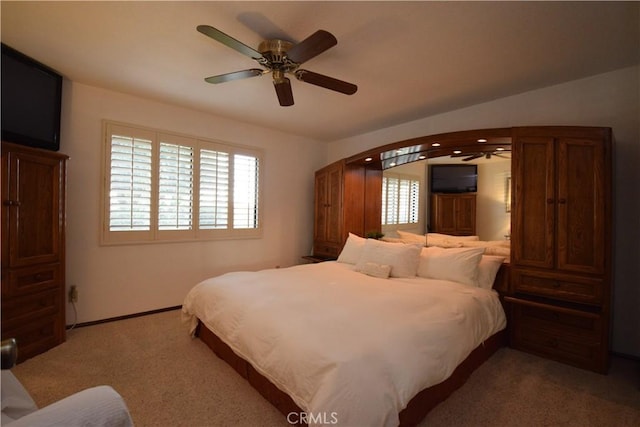 bedroom with light colored carpet and ceiling fan