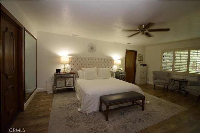 bedroom featuring ceiling fan and dark wood-type flooring