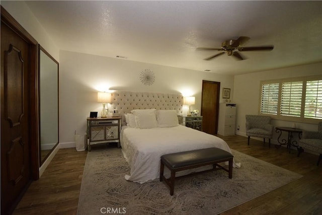 bedroom with dark wood-type flooring and ceiling fan