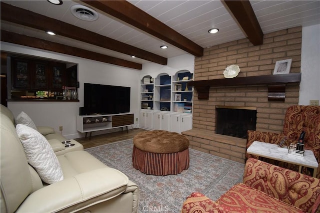 living room with a brick fireplace, hardwood / wood-style floors, and beam ceiling