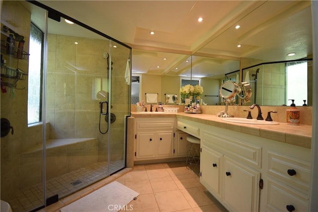 bathroom featuring vanity, a shower with shower door, and tile patterned flooring