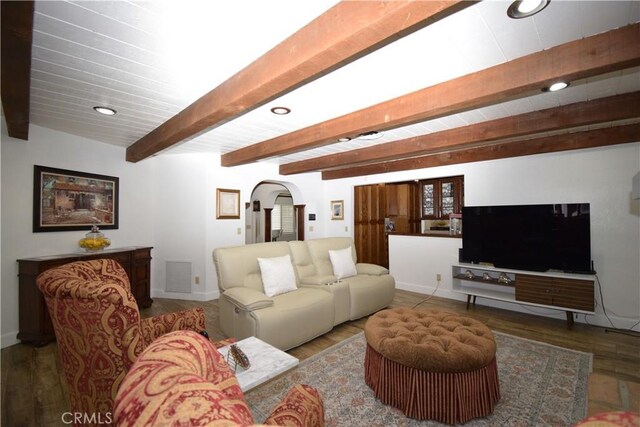 living room featuring beam ceiling and dark wood-type flooring