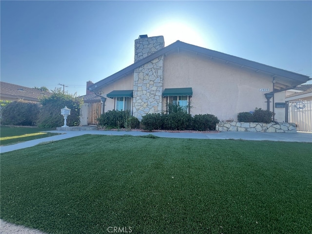 view of side of home with a lawn