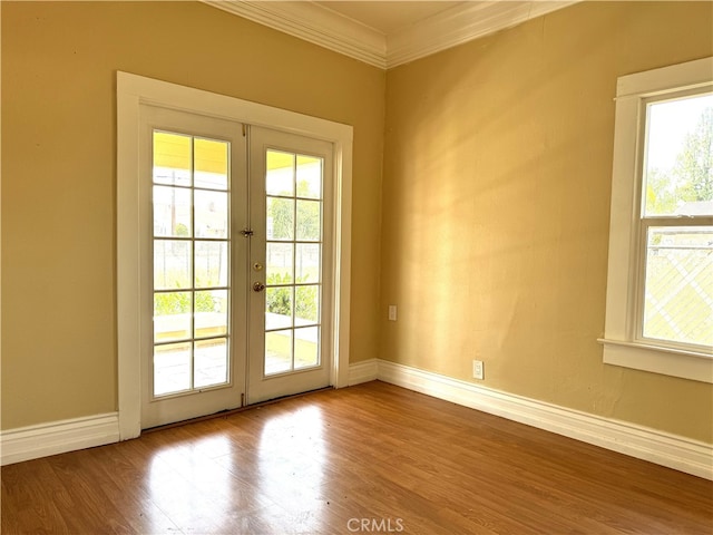 entryway with french doors, ornamental molding, and hardwood / wood-style floors