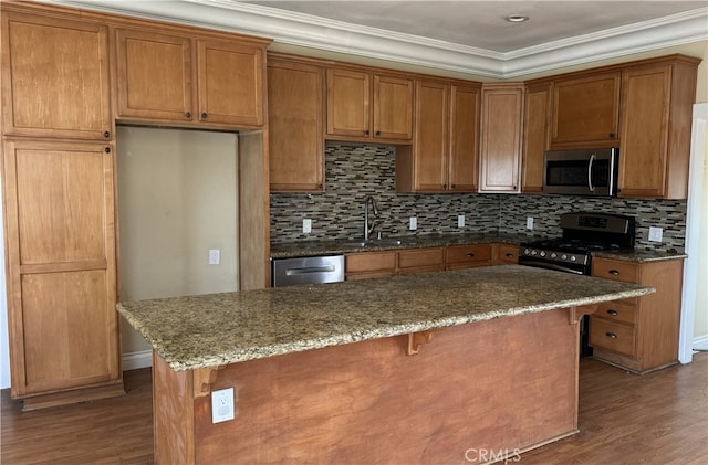 kitchen featuring backsplash, appliances with stainless steel finishes, dark hardwood / wood-style flooring, ornamental molding, and stone countertops