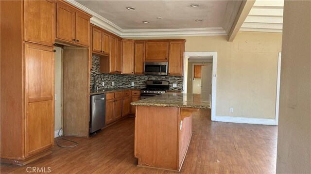 26759 Columbia St, Hemet, CA 92544 - kitchen with stainless steel appliances, ornamental molding, wood finished floors, dark stone counters, and backsplash