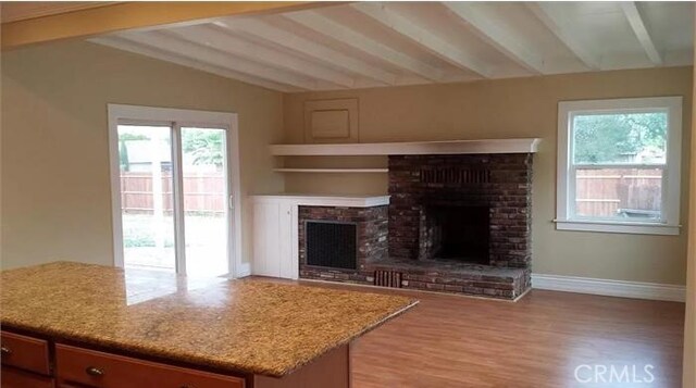 26759 Columbia St, Hemet, CA 92544 - unfurnished living room featuring a fireplace and light wood-type flooring