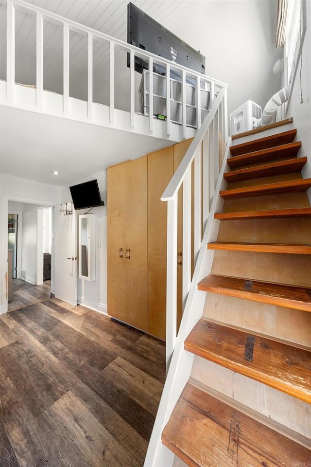 stairs featuring hardwood / wood-style floors