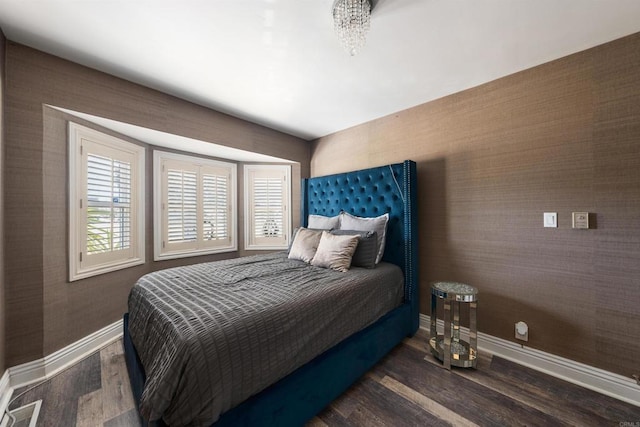 bedroom with dark hardwood / wood-style floors