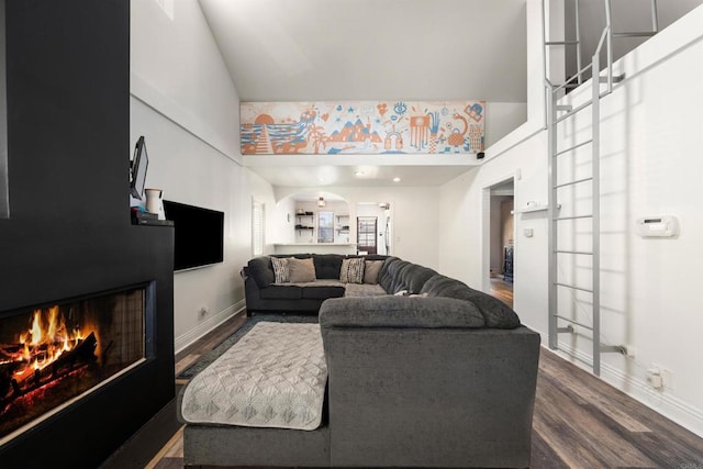 living room with dark hardwood / wood-style floors and a high ceiling