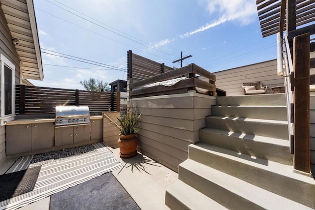 view of patio with an outdoor kitchen and area for grilling