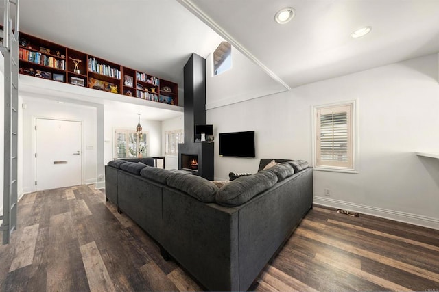 living room featuring plenty of natural light and dark wood-type flooring