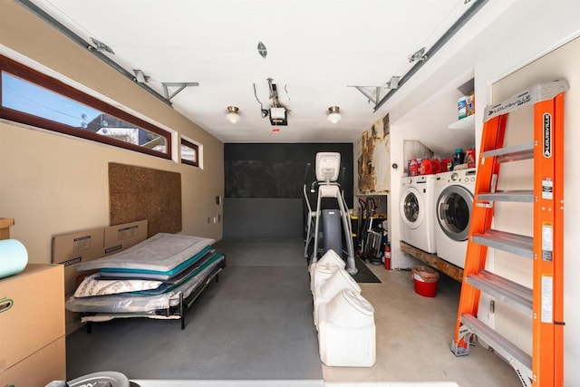 garage with a garage door opener and separate washer and dryer