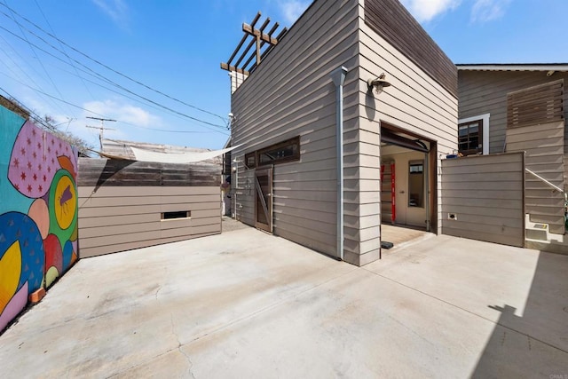 view of side of property featuring a patio