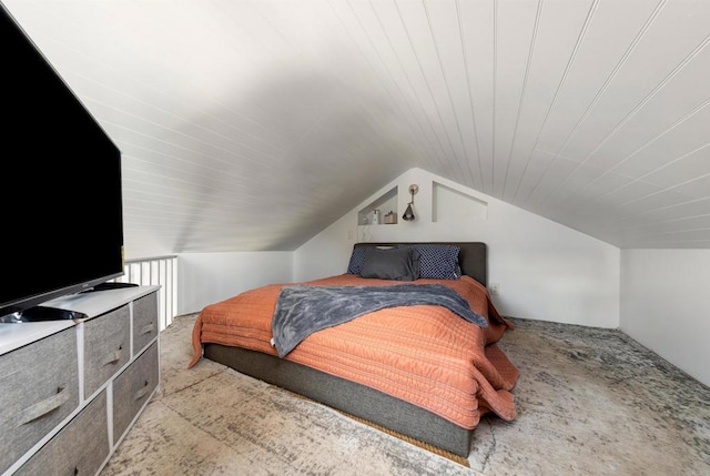 carpeted bedroom with vaulted ceiling