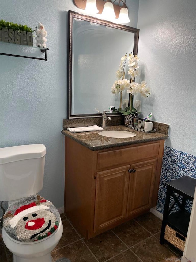 bathroom with vanity, toilet, and tile patterned flooring