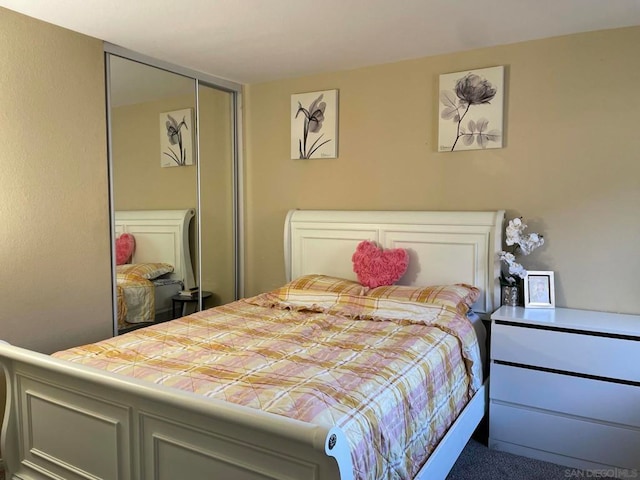 carpeted bedroom with a closet