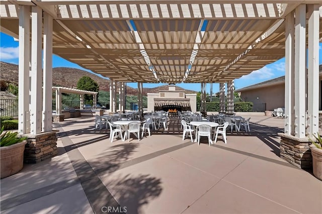 view of patio with a pergola and a mountain view