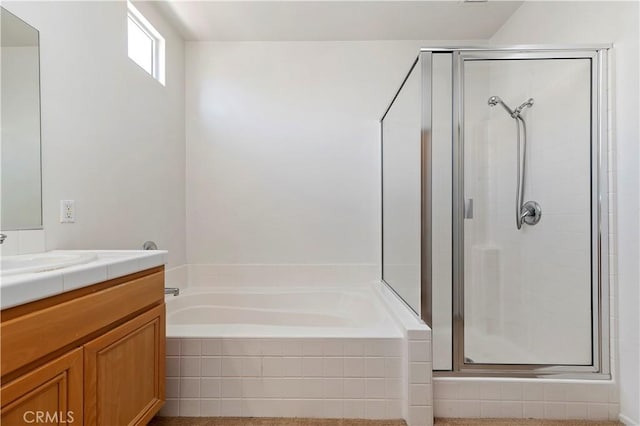 bathroom with vanity and shower with separate bathtub