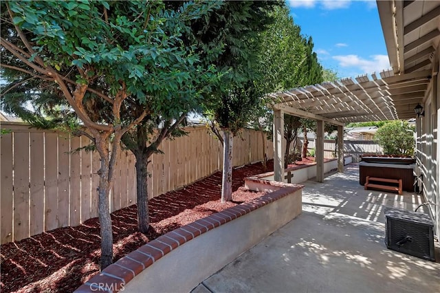 view of patio / terrace with a pergola and a hot tub