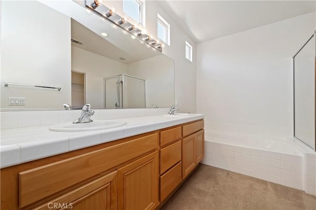 bathroom featuring shower with separate bathtub and vanity