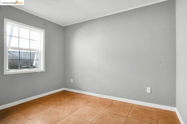 unfurnished room with light tile patterned floors and crown molding