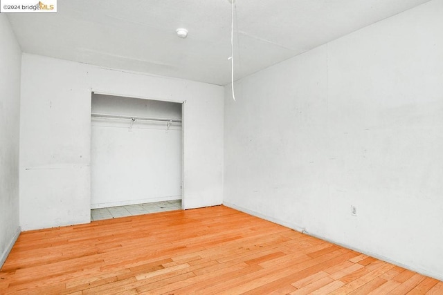 unfurnished bedroom with hardwood / wood-style floors