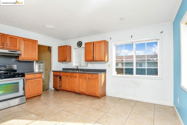 kitchen with light tile patterned floors, gas stove, crown molding, and range hood