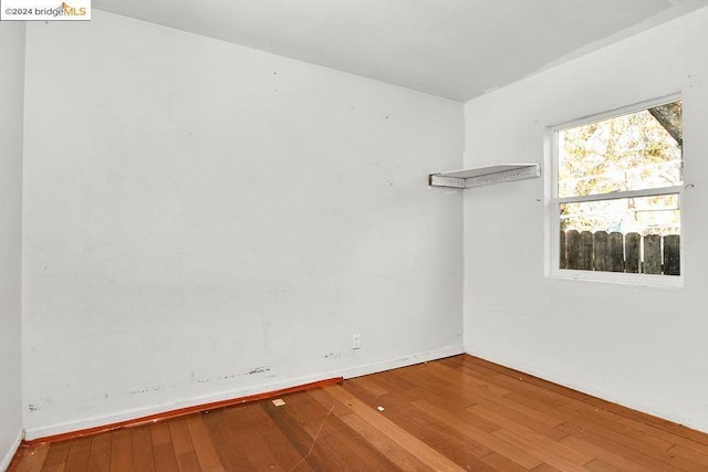 spare room with wood-type flooring