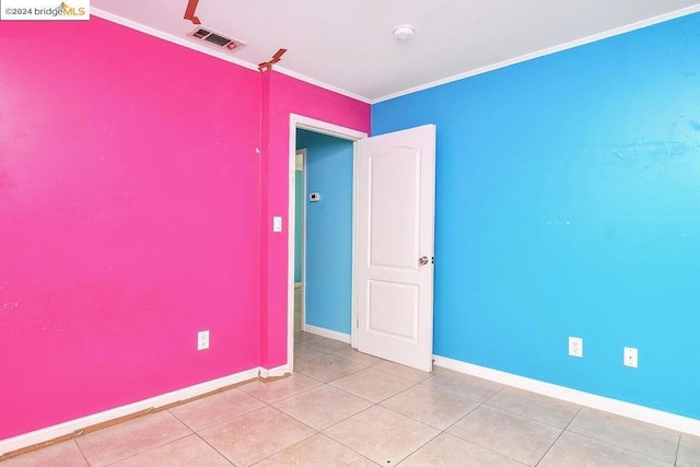 tiled empty room with crown molding