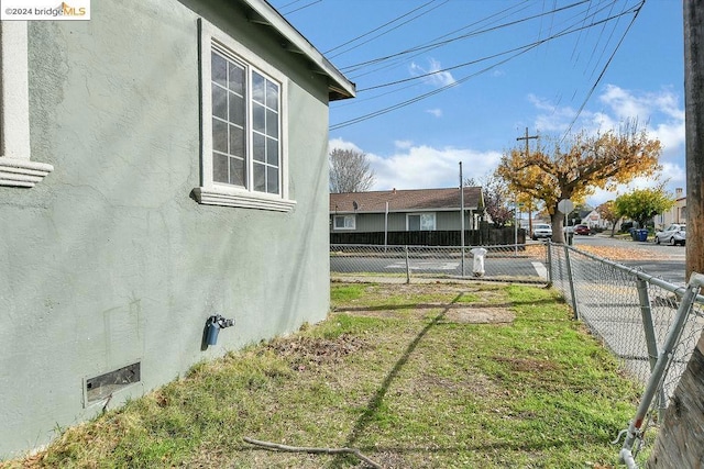 view of side of home featuring a yard