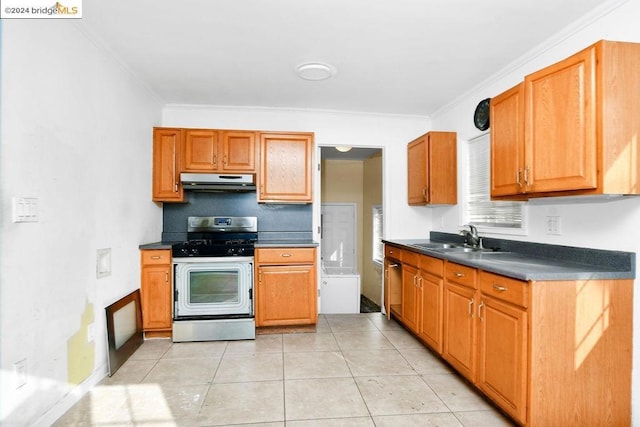 kitchen featuring white gas range, sink, light tile patterned floors, and ornamental molding