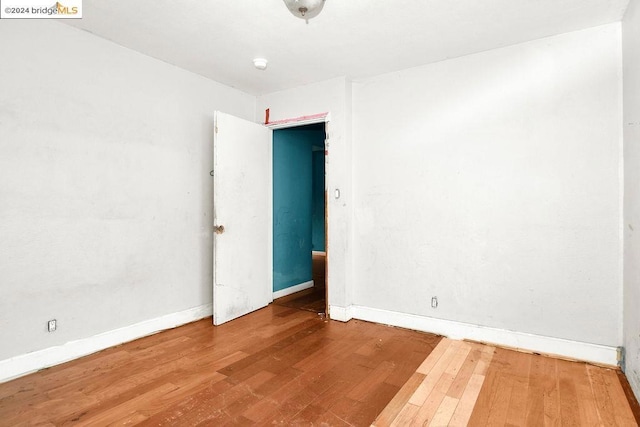 unfurnished room featuring hardwood / wood-style floors