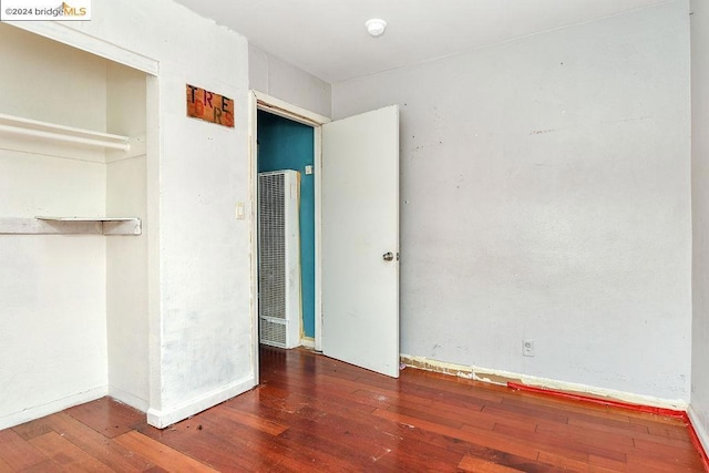 unfurnished bedroom featuring dark wood-type flooring