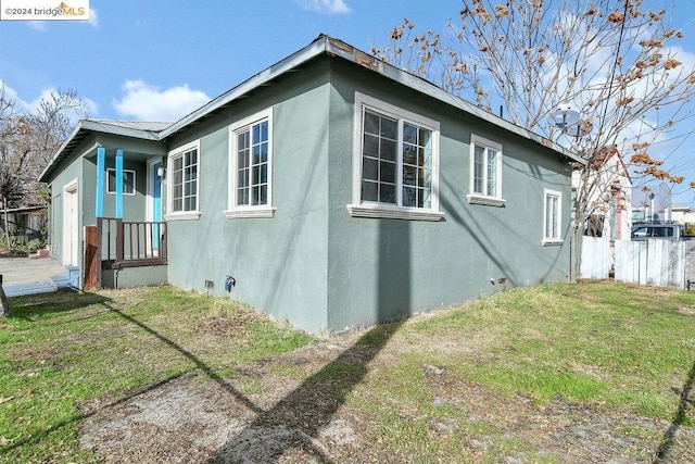 view of property exterior with a lawn