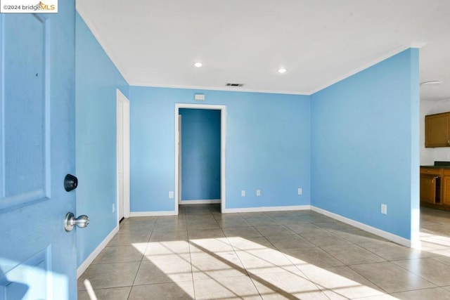 tiled empty room with crown molding