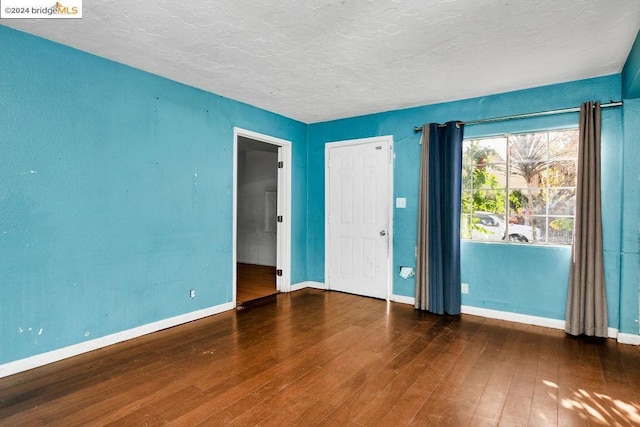 empty room featuring dark hardwood / wood-style flooring