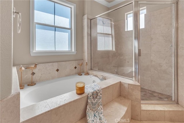 bathroom featuring plenty of natural light and independent shower and bath