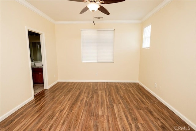 spare room featuring ceiling fan, dark hardwood / wood-style flooring, and crown molding