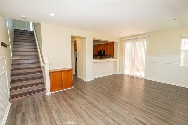 unfurnished living room featuring dark wood-type flooring