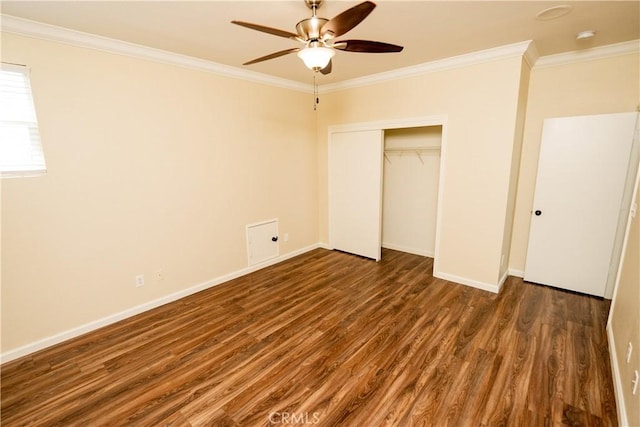 unfurnished bedroom featuring ceiling fan, dark hardwood / wood-style flooring, ornamental molding, and a closet