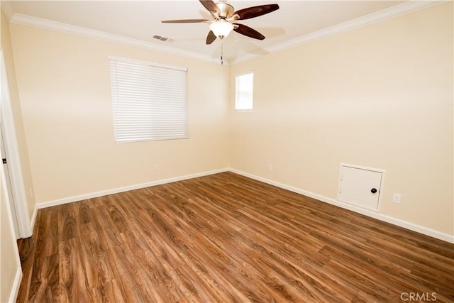 spare room featuring crown molding, ceiling fan, and dark wood-type flooring