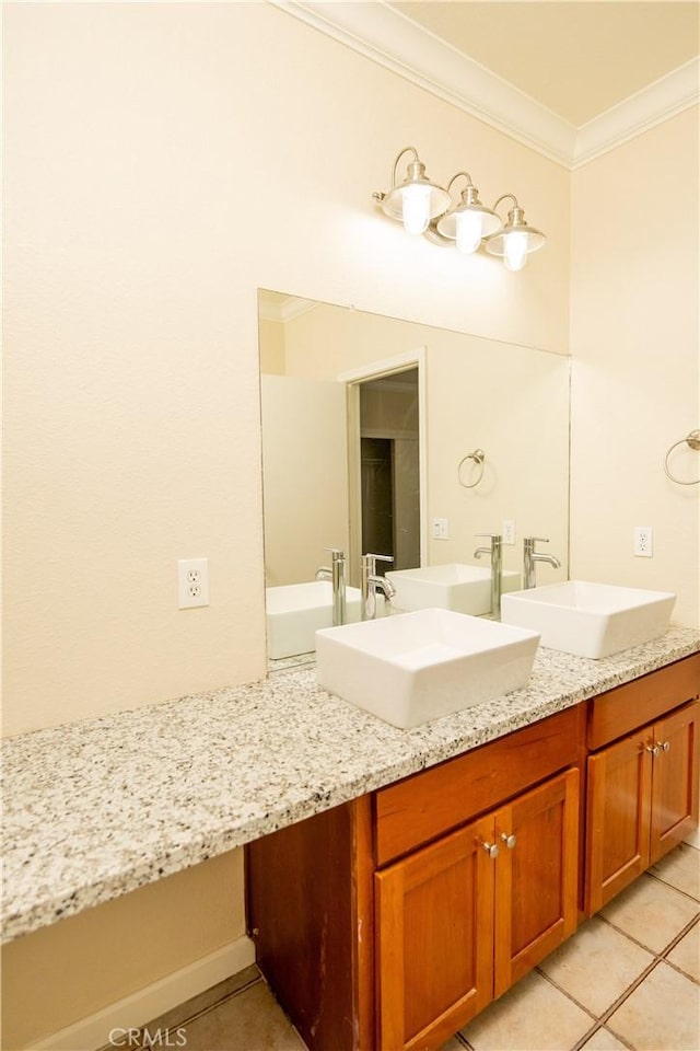 bathroom featuring tile patterned flooring, vanity, and crown molding