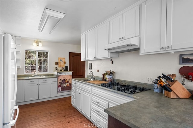 kitchen with white cabinetry, white fridge, and dishwasher