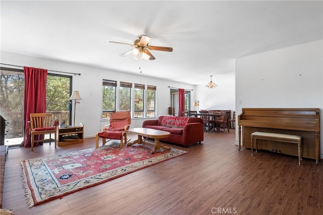 living room featuring ceiling fan and dark hardwood / wood-style flooring