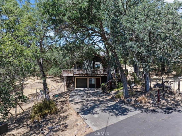 19680 Sugarwood Ct, Hidden Valley Lake, CA 95467 - view of property hidden behind natural elements with an attached garage, a wooden deck, driveway, and stairway