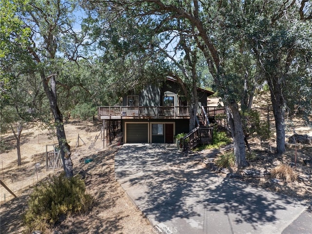 view of front of property featuring a wooden deck and a garage